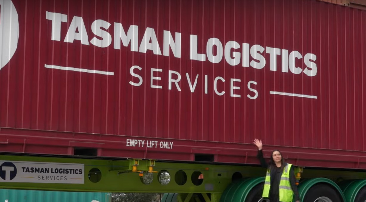 Woman standing next to a large truck | Logistics Services | Tasman Logistics Services