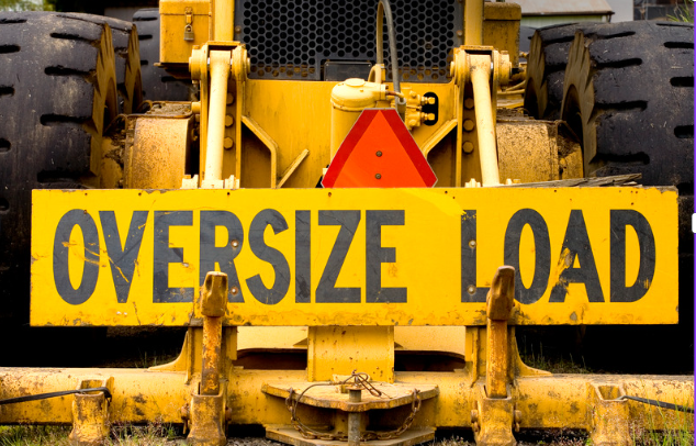 Yellow sign displaying oversize load on a road | Road Transport | Tasman Logistics Services