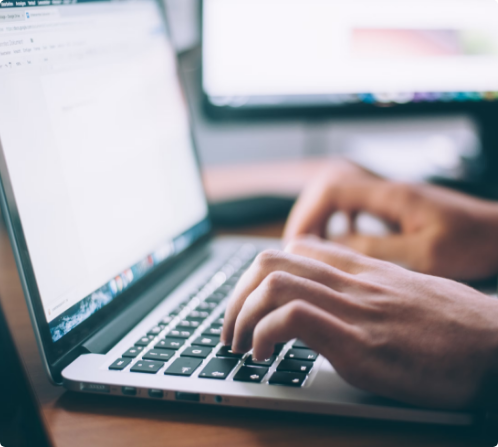 Person typing on a laptop computer | Logistics Project Management | Tasman Logistics Services