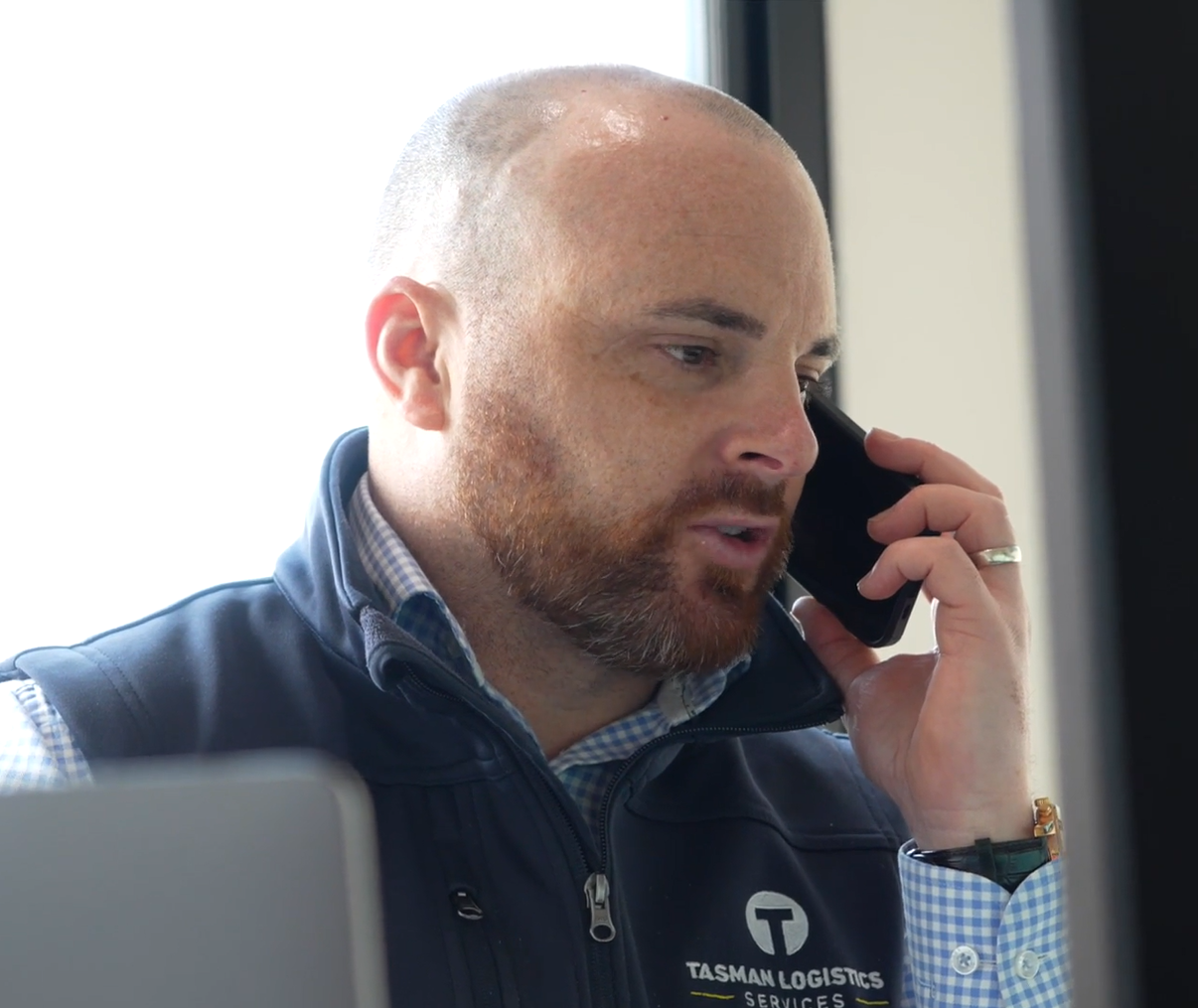 Man talking on a cell phone | Logistics Project Management | Tasman Logistics Services