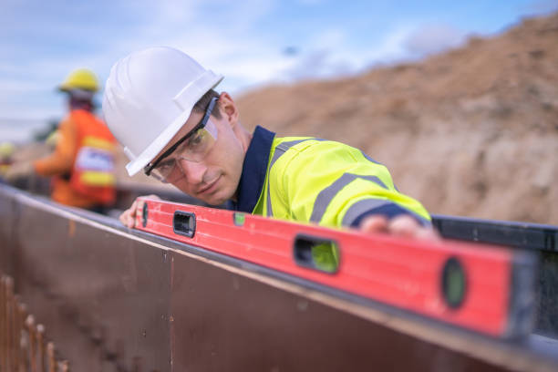 Construction worker using a level | Rail Freight Australia | Tasman Logistics Services