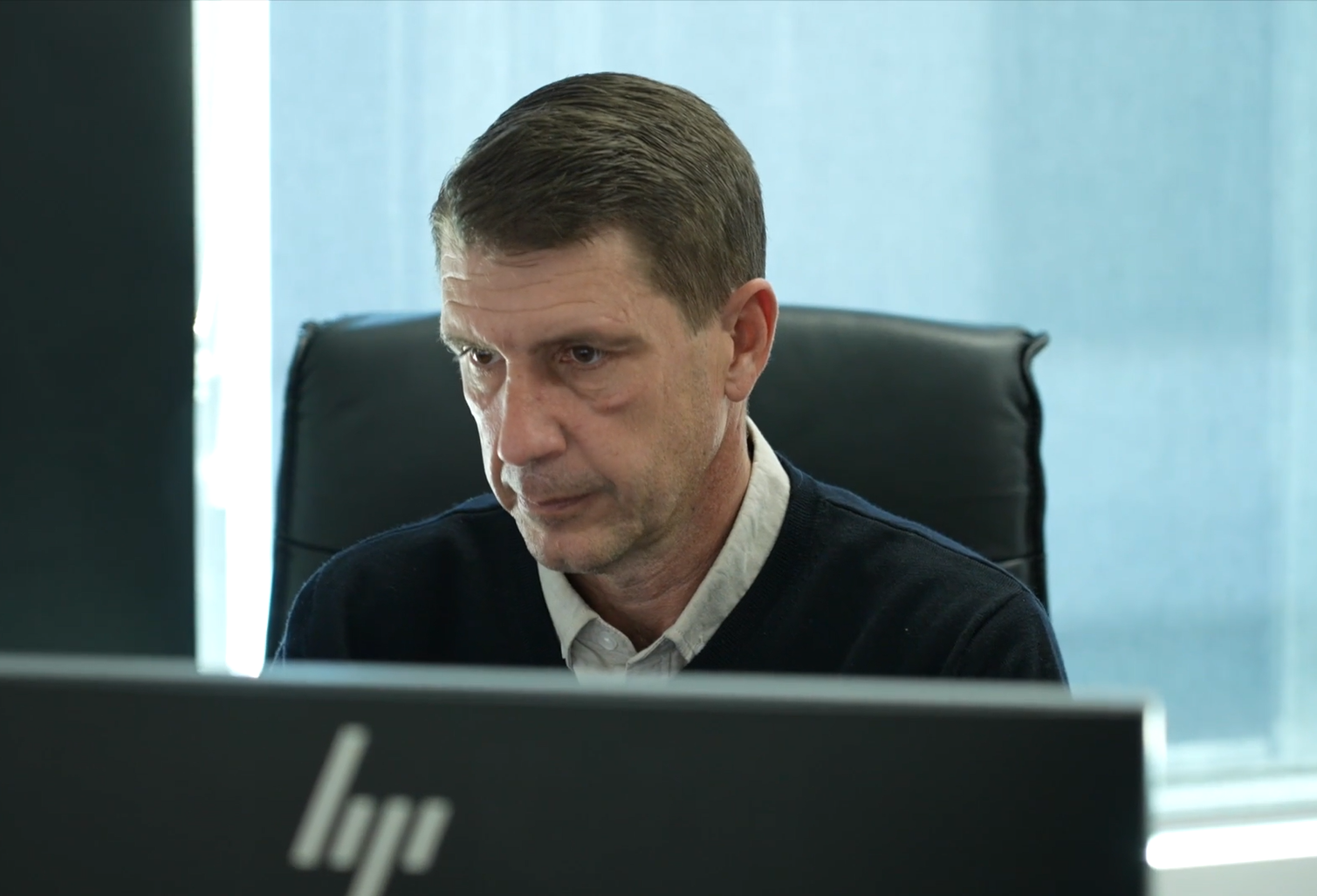 Man sitting at a desk focused on computer screen | Logistics Services | Tasman Logistics Services